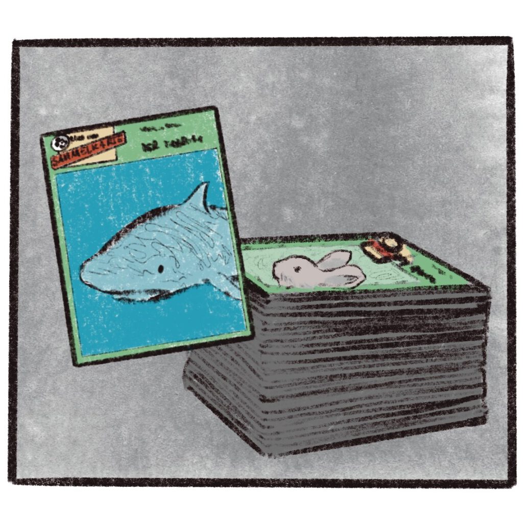 Panel from a comic page showing collectible cards from the Micky Maus magazine about animal species, sometimes with a focus on endangered species (here: a shark, in the background a certain type of rabbit)